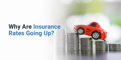 Why are insurance rates going up? Car propped up by stack of quarters.